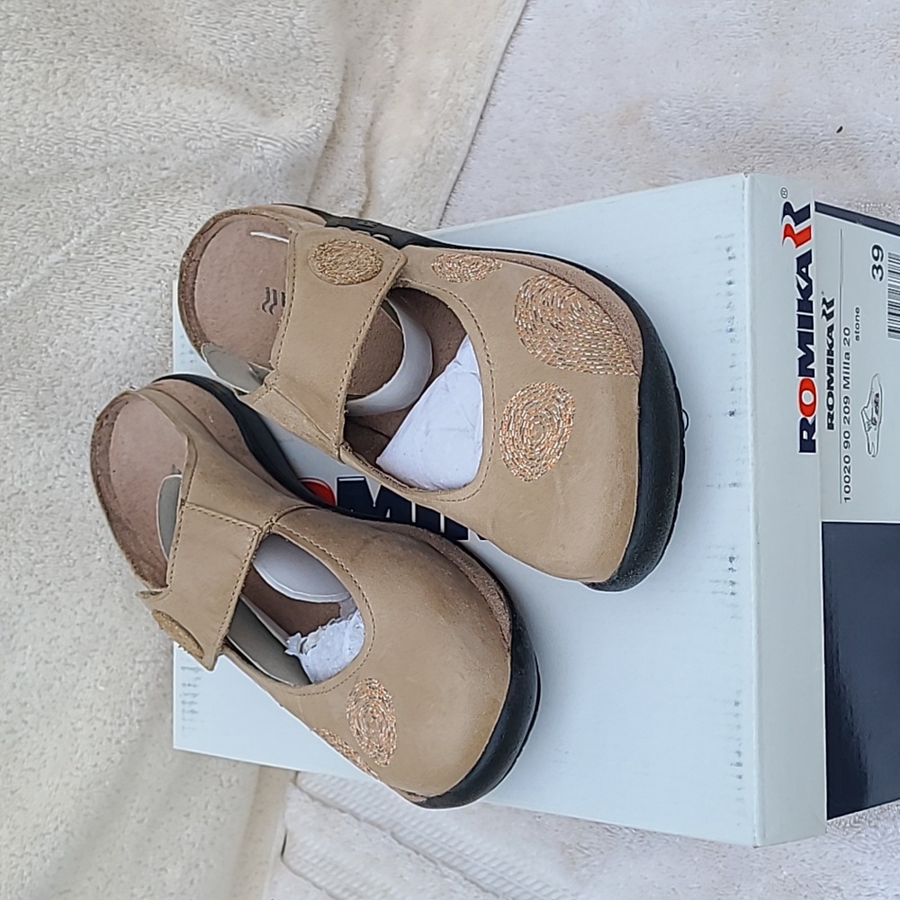 Beautiful, never worn, Romika slip-on adjustable clogs.